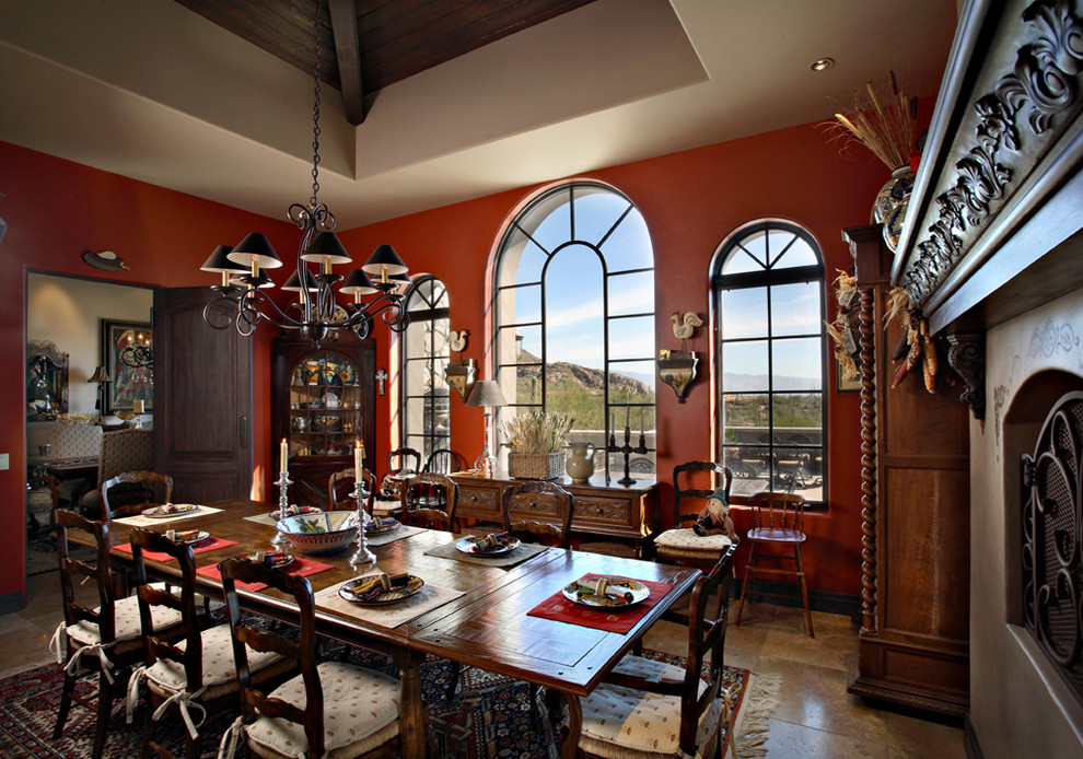 Свежая идея для дизайна: столовая в средиземноморском стиле с красными стенами и стандартным камином - отличное фото интерьера