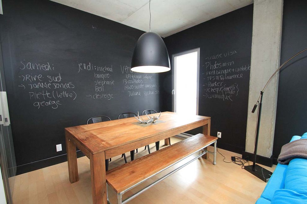 Design ideas for a small contemporary open plan dining room in Montreal with black walls and light hardwood flooring.