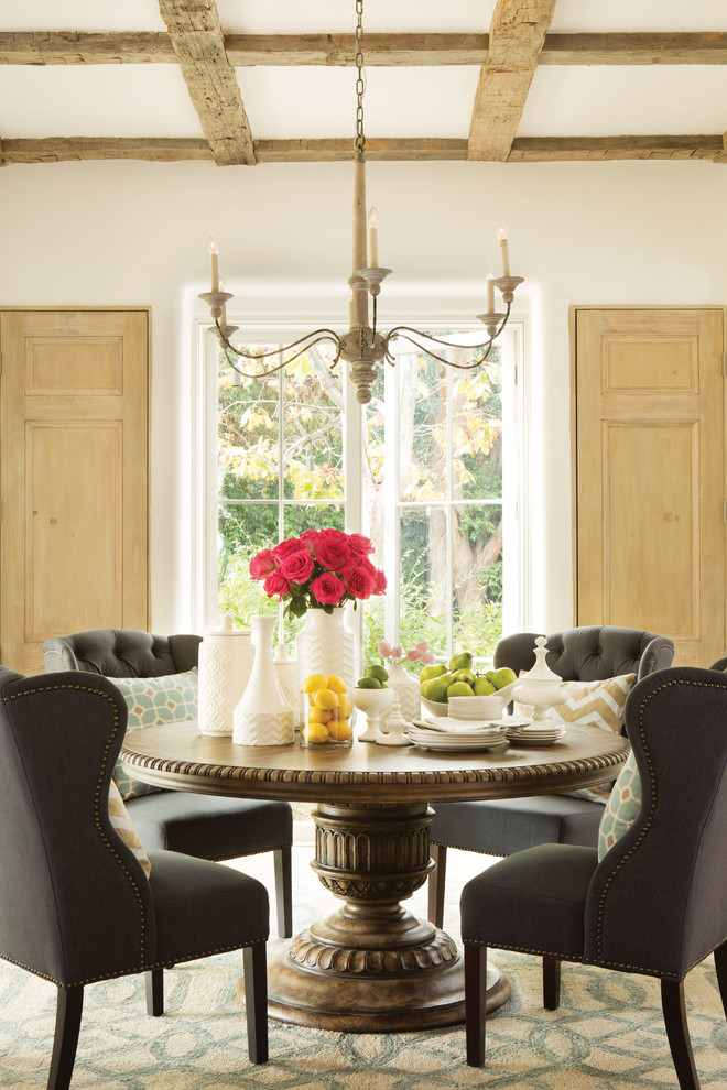 Mid-sized elegant medium tone wood floor enclosed dining room photo in Los Angeles with beige walls