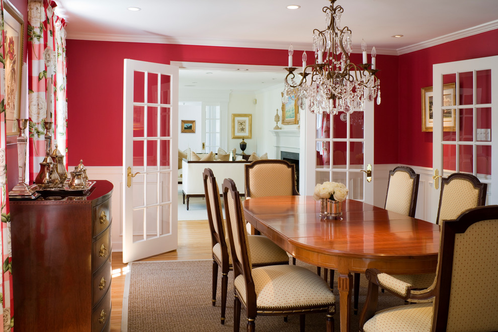 Example of a classic dining room design in Philadelphia with red walls
