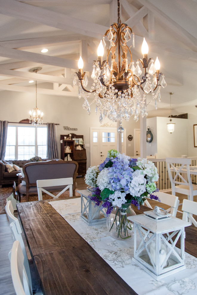 Example of a mid-sized cottage chic light wood floor and multicolored floor great room design in Other with white walls and no fireplace
