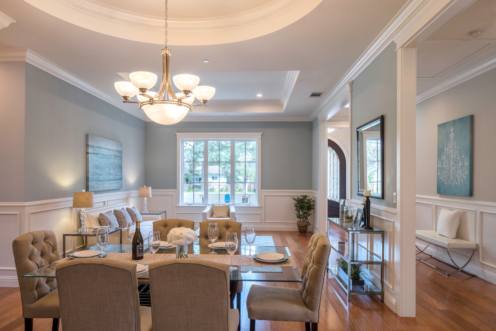 Inspiration for a large classic open plan dining room in San Francisco with grey walls, medium hardwood flooring, no fireplace and feature lighting.