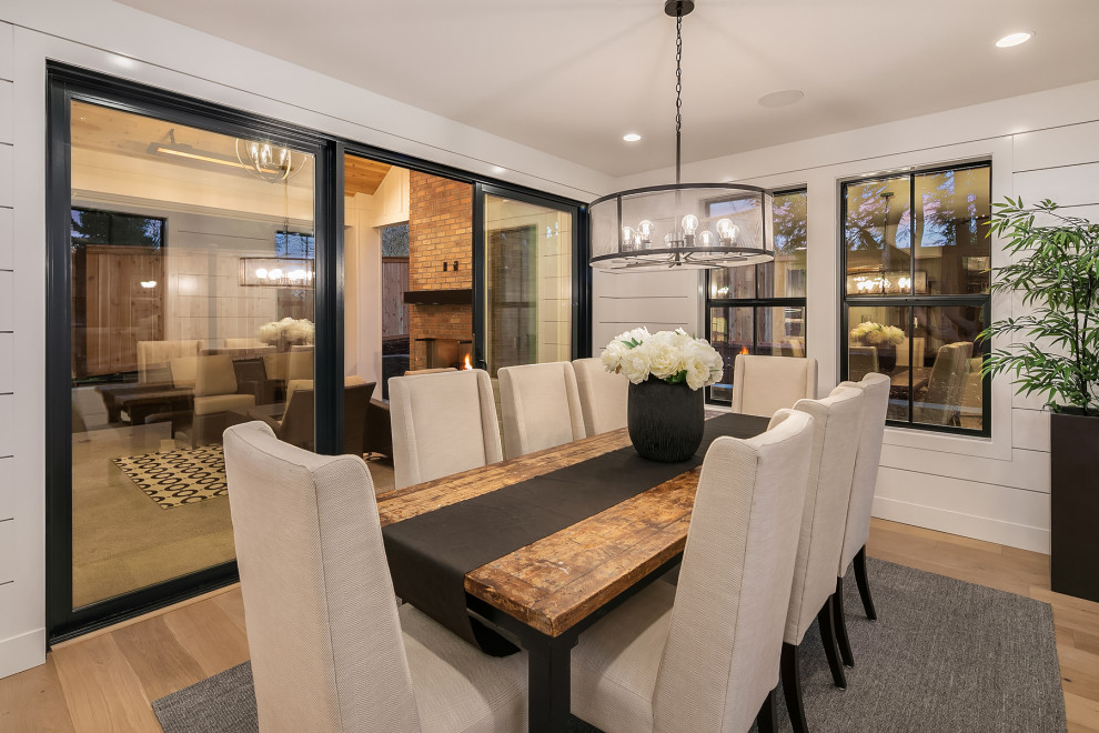 Design ideas for a large country open plan dining room in Seattle with white walls and medium hardwood flooring.