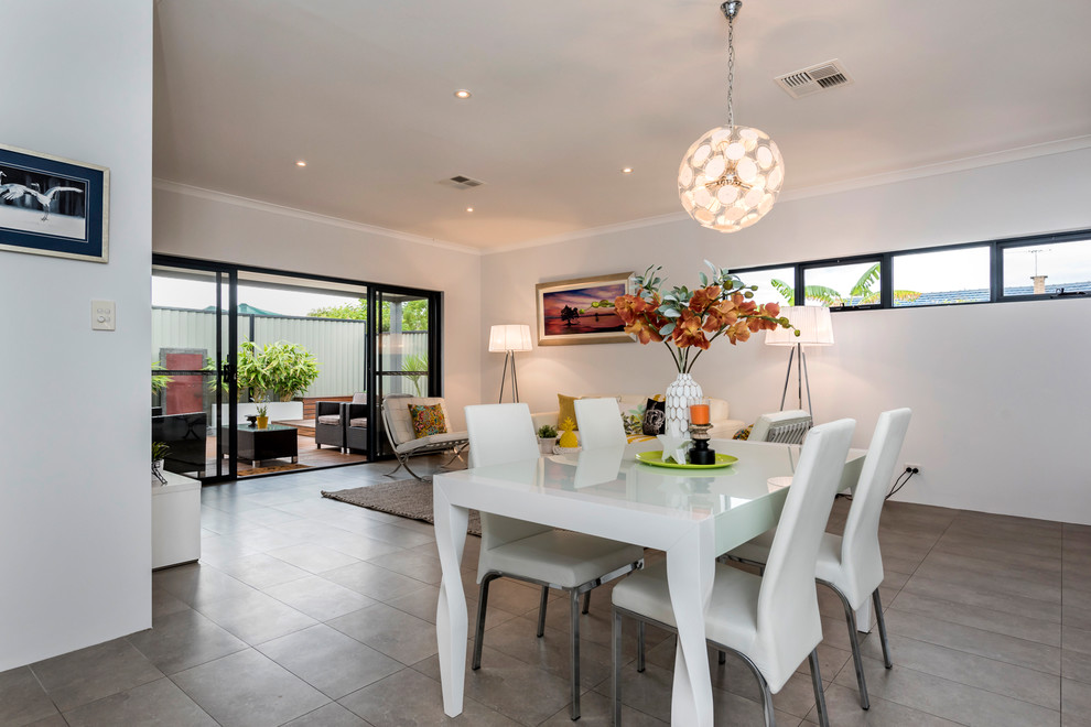 Design ideas for a contemporary open plan dining room in Perth with white walls, ceramic flooring and grey floors.