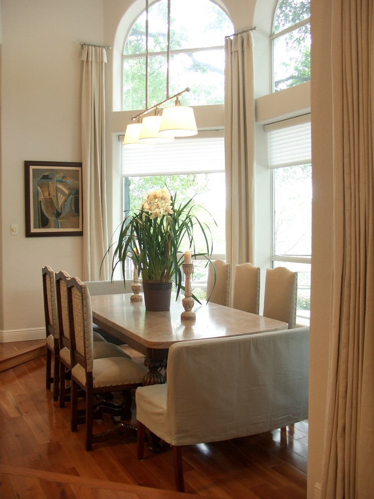 Elegant dark wood floor dining room photo in Houston with beige walls