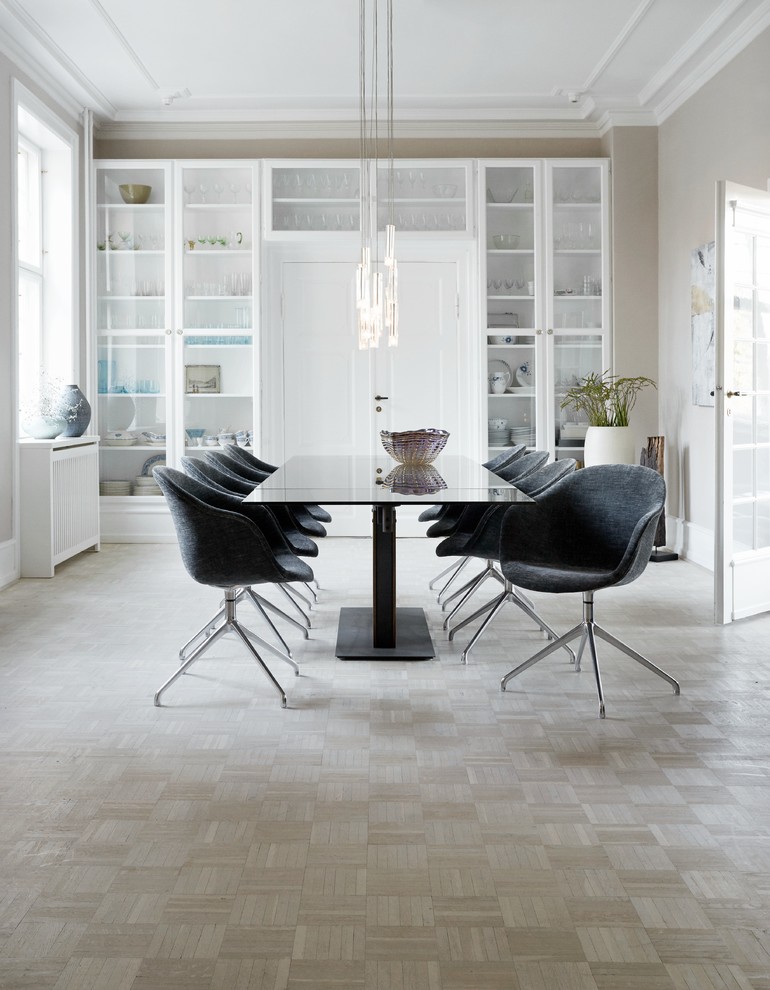 Photo of a scandinavian dining room in London with grey walls and light hardwood flooring.