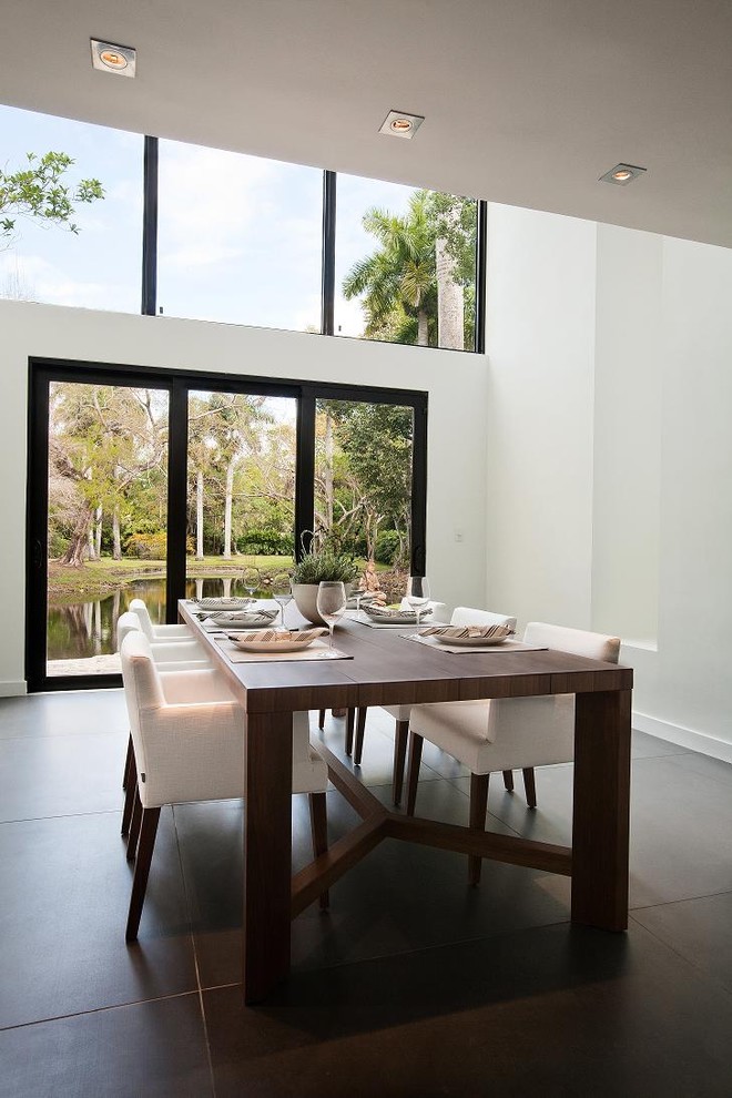 This is an example of a large contemporary enclosed dining room in Miami with white walls.