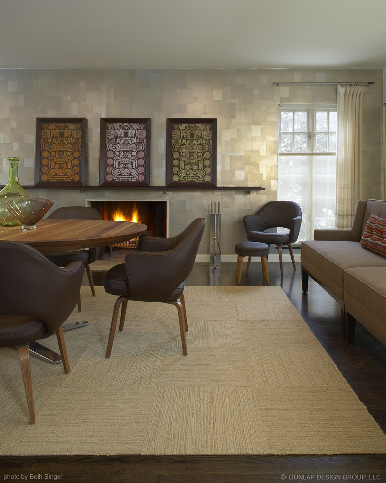 This is an example of a contemporary dining room in Detroit with dark hardwood flooring and a standard fireplace.