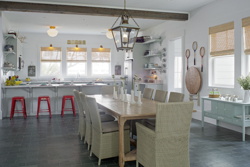 Example of a large beach style slate floor and gray floor great room design in Atlanta with white walls and no fireplace