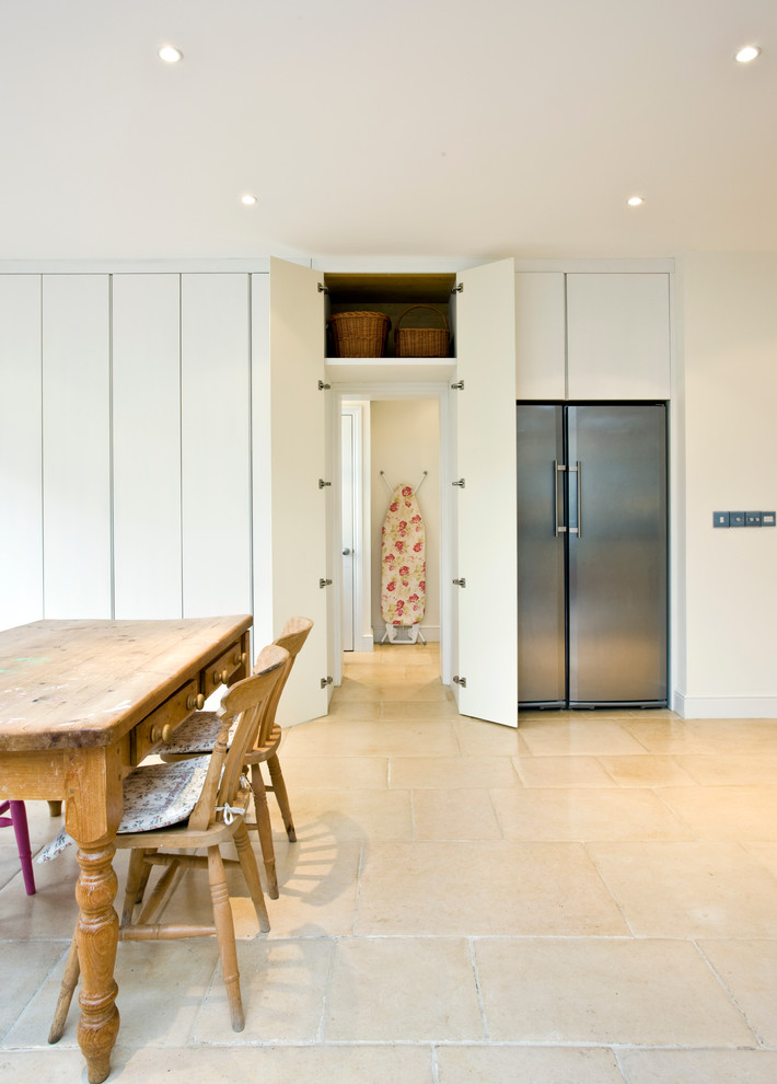 Dining room - contemporary dining room idea in Surrey with white walls
