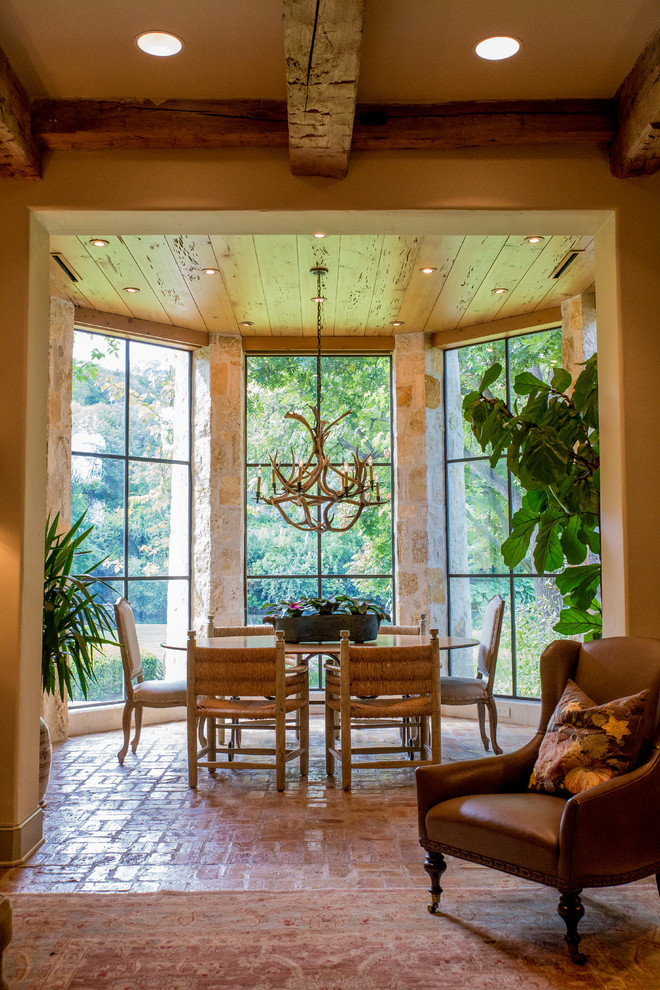 Example of a mid-sized mountain style brick floor enclosed dining room design in Austin with beige walls and no fireplace