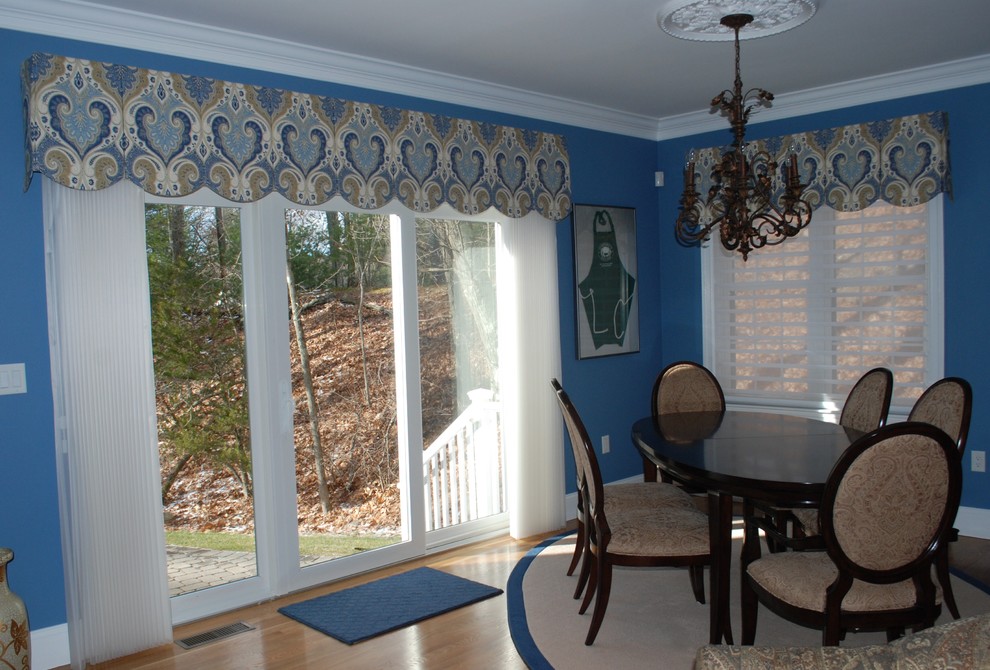 Example of a mid-sized classic medium tone wood floor and brown floor kitchen/dining room combo design in Boston with blue walls and no fireplace
