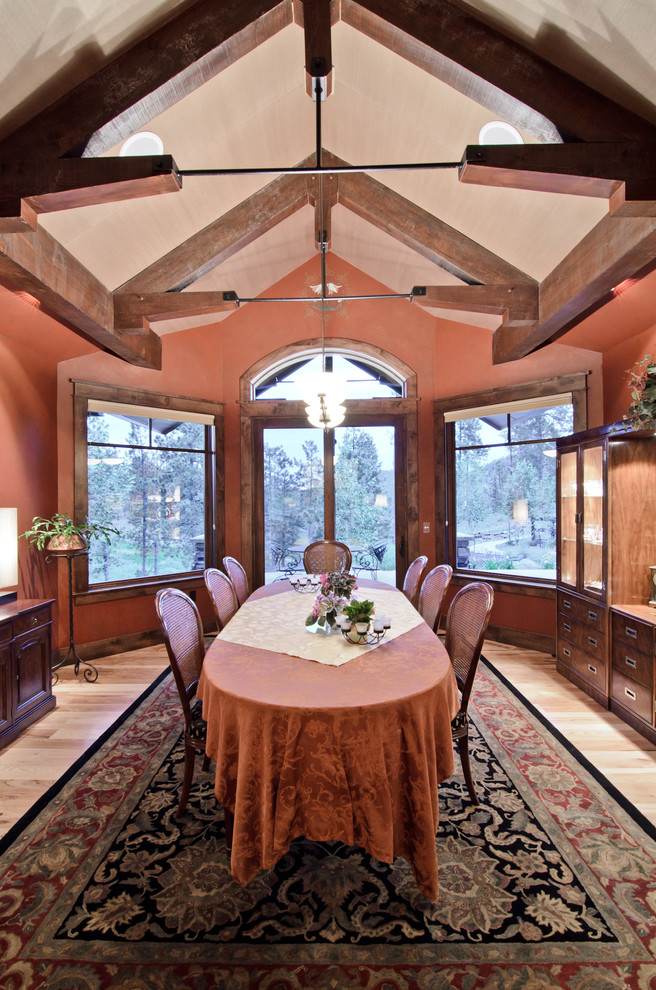 This is an example of a classic dining room in Denver with medium hardwood flooring and pink walls.