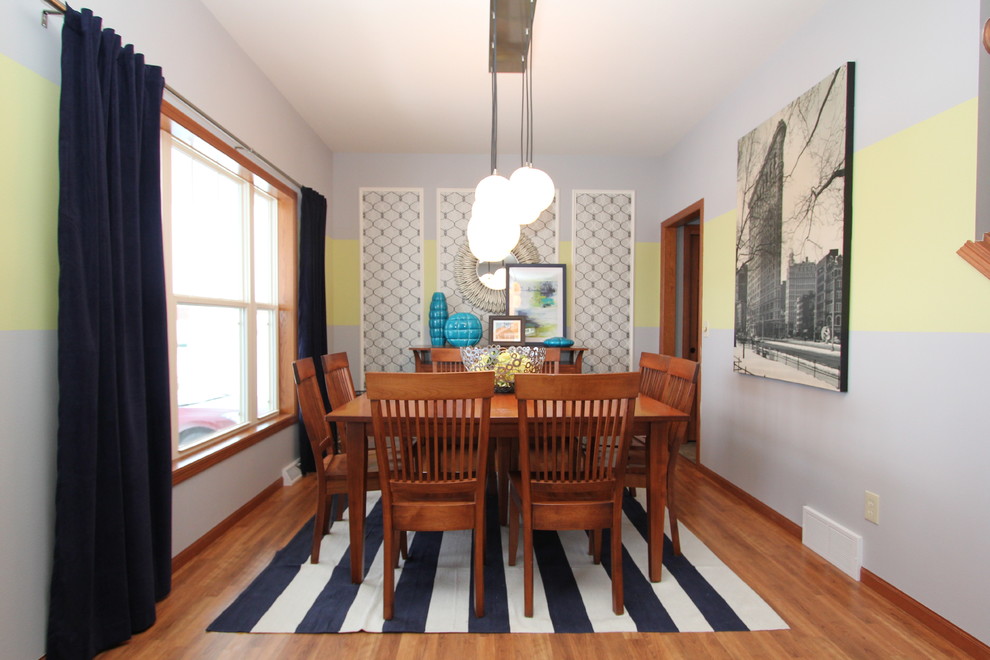 Inspiration for a mid-sized eclectic medium tone wood floor and brown floor enclosed dining room remodel in Milwaukee with multicolored walls and no fireplace