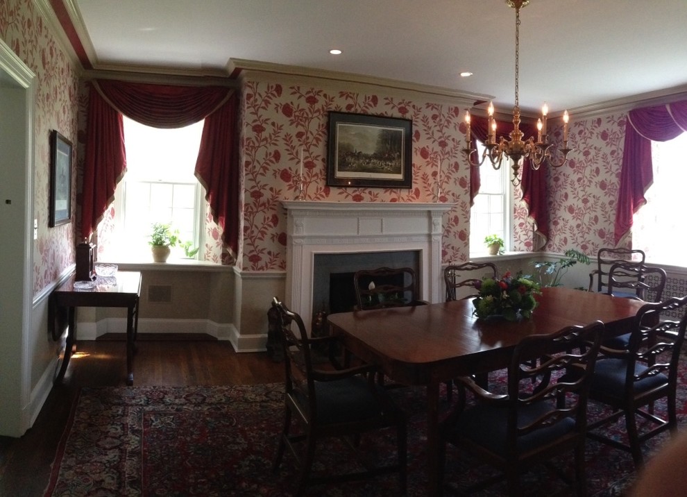 Example of a mid-sized classic dark wood floor enclosed dining room design in Baltimore with multicolored walls, a standard fireplace and a wood fireplace surround