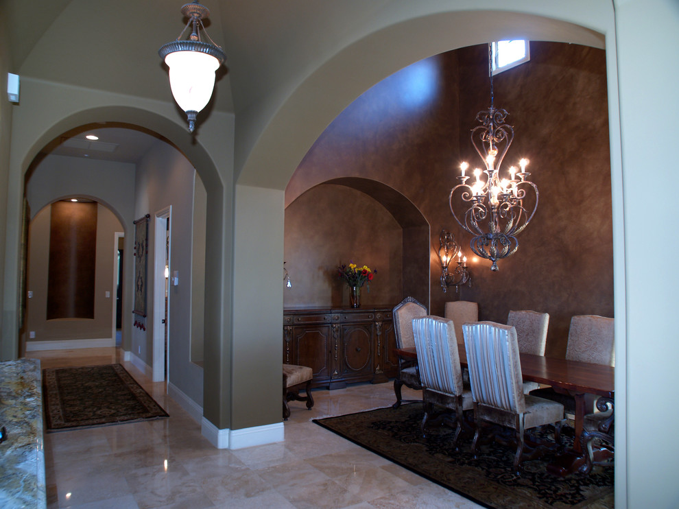 Inspiration for a huge mediterranean beige floor and vaulted ceiling enclosed dining room remodel in Las Vegas with beige walls, a corner fireplace and a plaster fireplace
