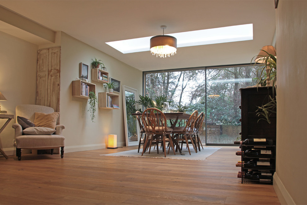 Photo of a medium sized contemporary kitchen/dining room in Surrey with white walls and medium hardwood flooring.