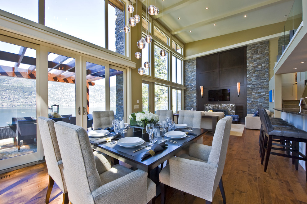 Inspiration for a contemporary dining room remodel in Vancouver with a stone fireplace