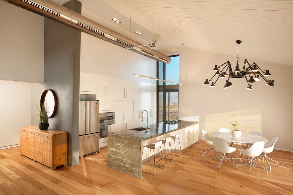 Esempio di una sala da pranzo aperta verso la cucina minimal con pareti bianche e pavimento in legno massello medio