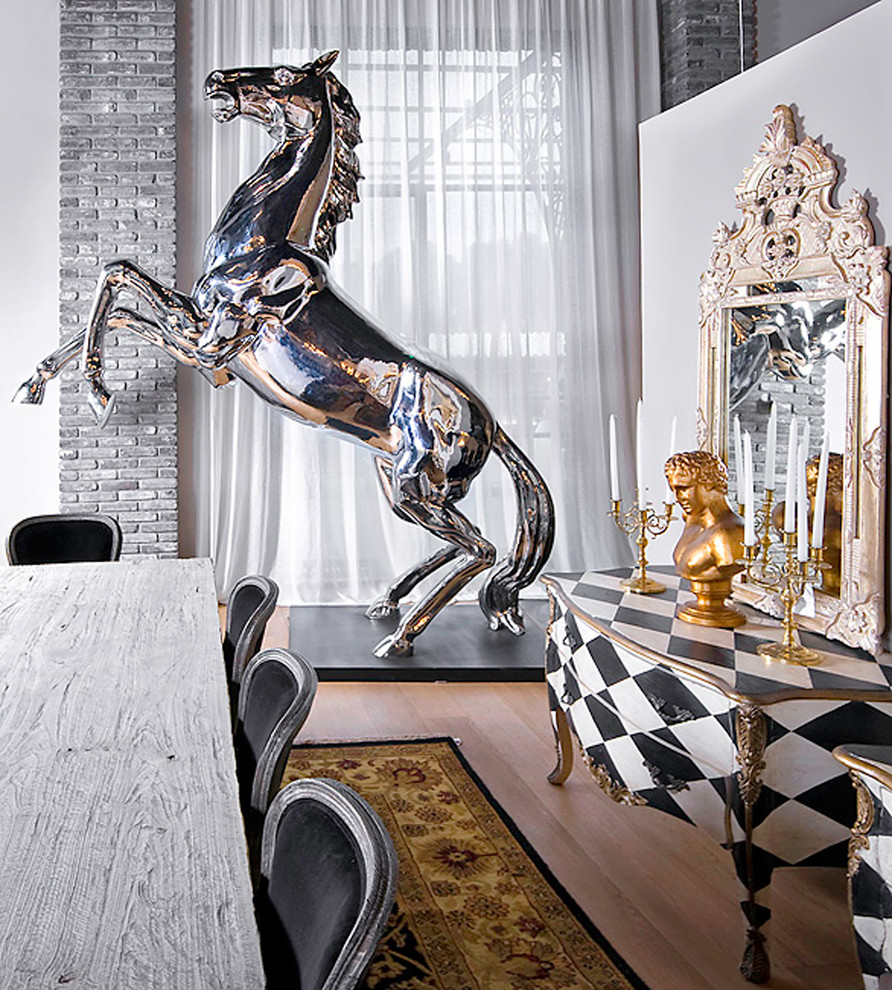 Example of an eclectic medium tone wood floor dining room design in Other with white walls
