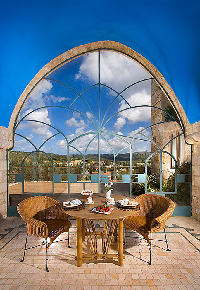 Example of a tuscan dining room design in Other