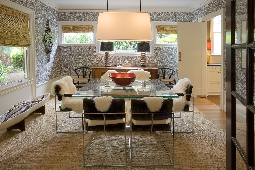 Example of a minimalist medium tone wood floor enclosed dining room design in Portland with multicolored walls