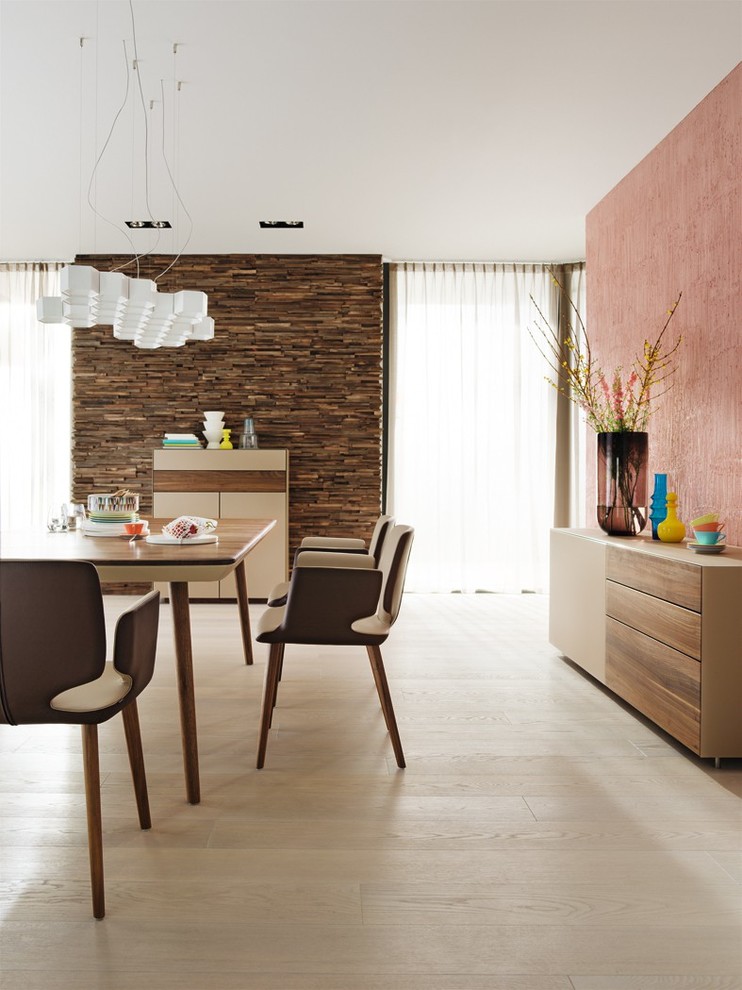 На фото: кухня-столовая в современном стиле с розовыми стенами и светлым паркетным полом