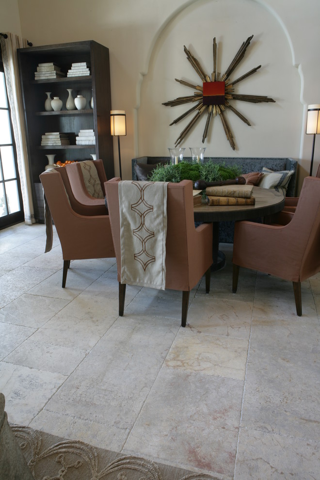 Kitchen/dining room combo - mid-sized mediterranean limestone floor kitchen/dining room combo idea in New York with a standard fireplace, a stone fireplace and beige walls