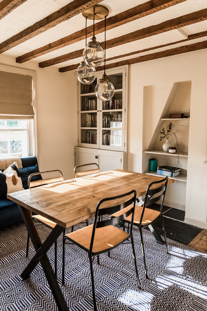 Esempio di una sala da pranzo scandinava chiusa e di medie dimensioni con pareti bianche, pavimento in legno massello medio, pavimento marrone e travi a vista