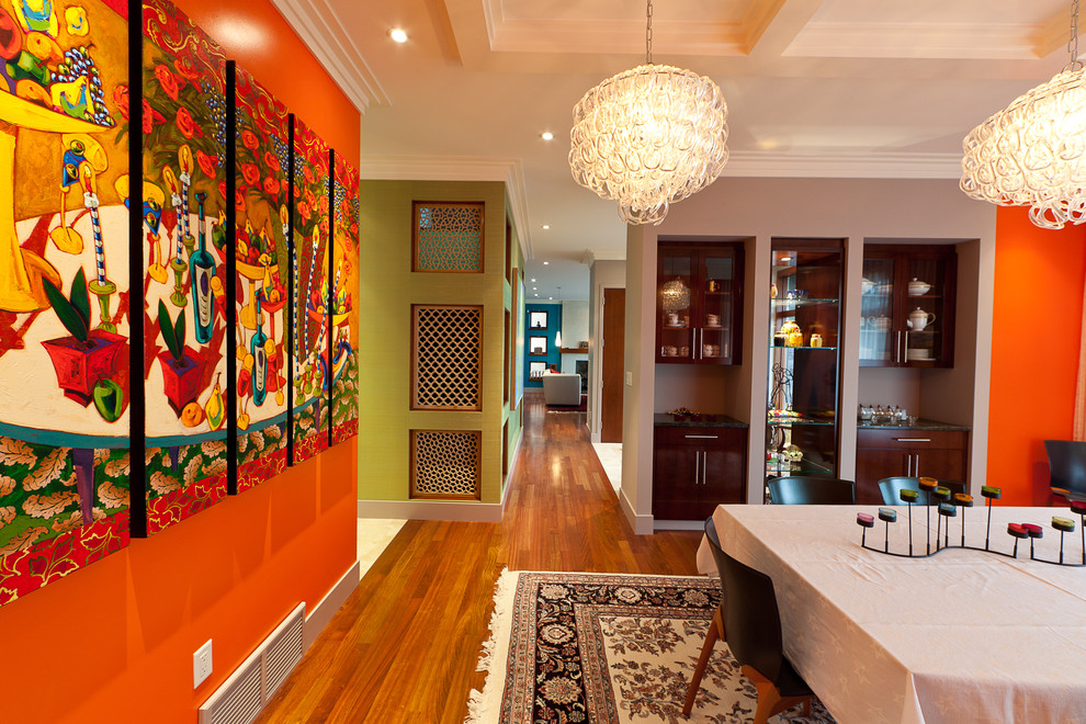 Inspiration for a contemporary dining room remodel in Edmonton with orange walls
