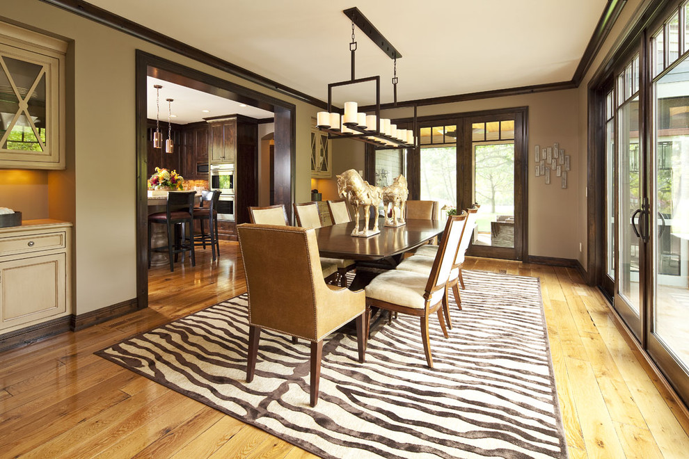 Enclosed dining room - contemporary medium tone wood floor enclosed dining room idea in Minneapolis with beige walls