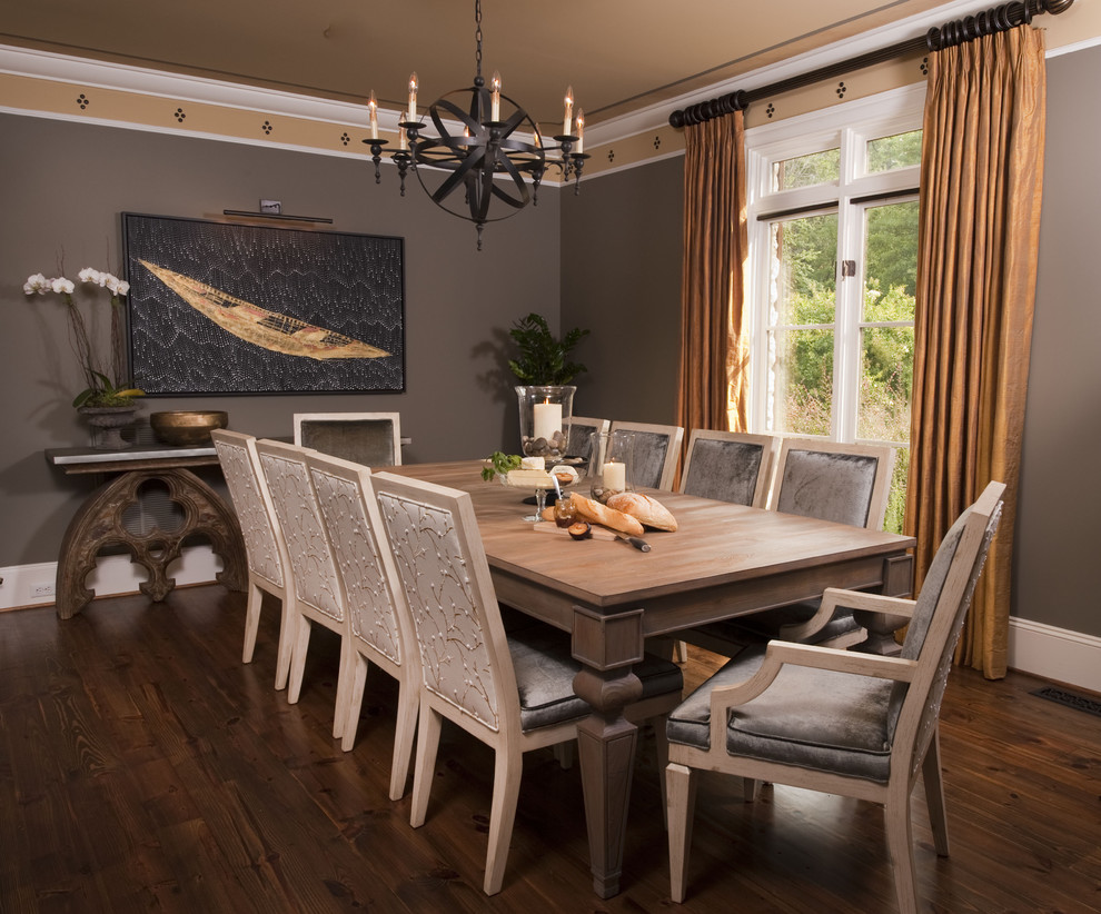 Photo of an eclectic dining room in Charlotte with brown walls and dark hardwood flooring.