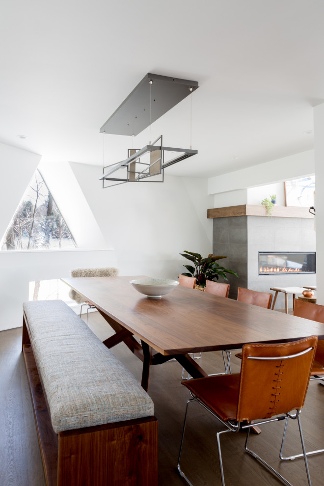 Photo of a contemporary dining room in Boston with white walls, dark hardwood flooring and brown floors.