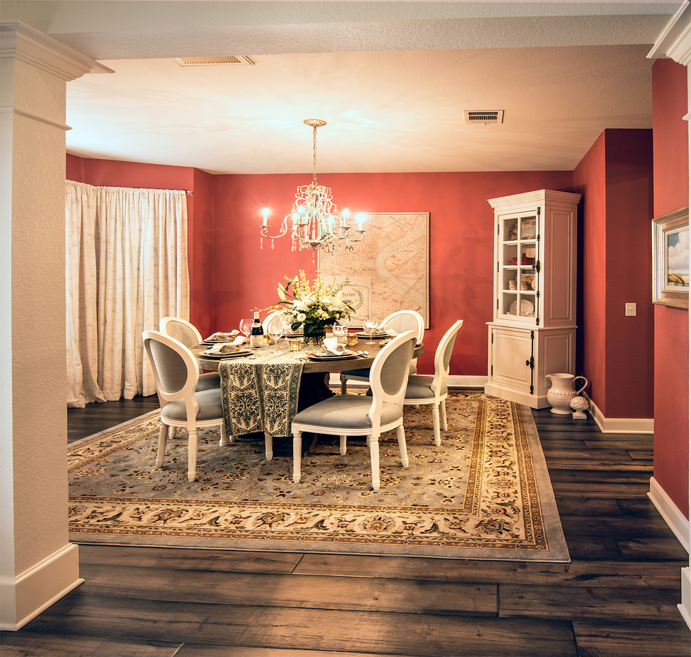 Example of a large classic dark wood floor enclosed dining room design in Austin with red walls
