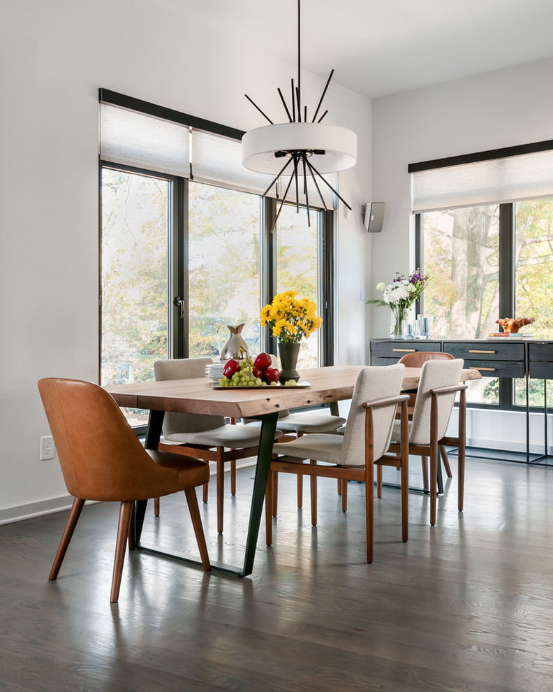Large contemporary kitchen/dining room in Atlanta with white walls, brown floors and dark hardwood flooring.