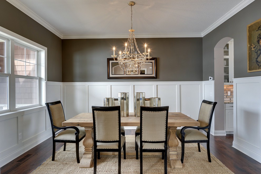 Example of a large transitional dark wood floor enclosed dining room design in Minneapolis with brown walls and no fireplace
