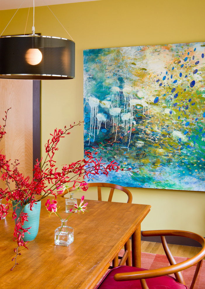 Example of a trendy dining room design in Boston with yellow walls