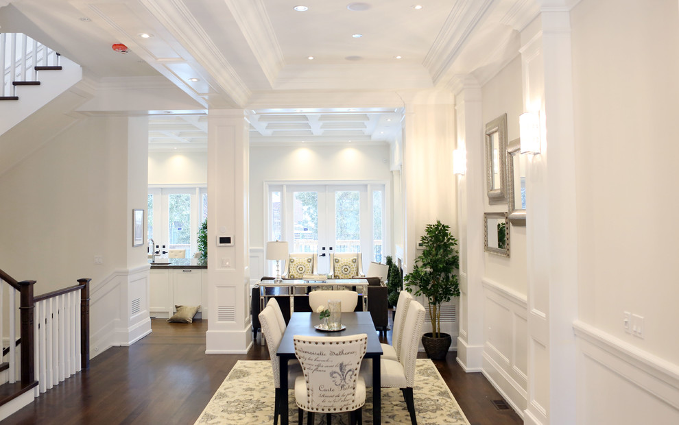 Inspiration for a medium sized classic open plan dining room in Toronto with white walls, light hardwood flooring and a standard fireplace.