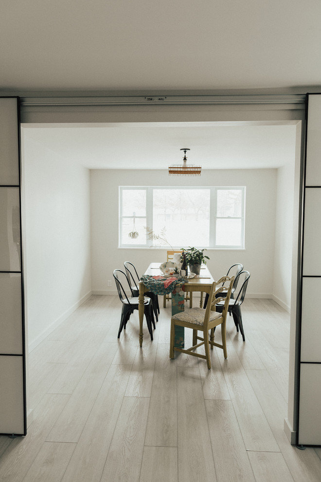 Ispirazione per una sala da pranzo nordica chiusa e di medie dimensioni con pareti bianche, pavimento in vinile e pavimento grigio
