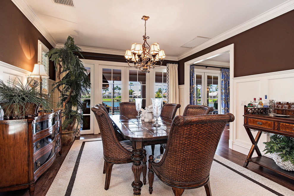 Medium sized world-inspired enclosed dining room in Miami with brown walls, dark hardwood flooring and no fireplace.