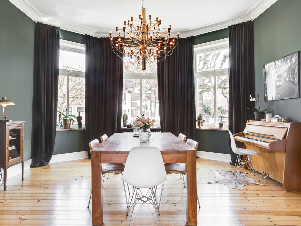 Inspiration for a mid-sized scandinavian light wood floor and beige floor dining room remodel in London with green walls