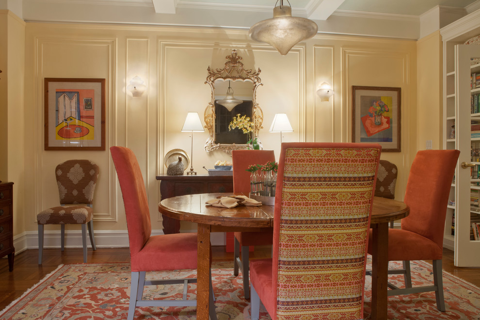 Mid-sized eclectic medium tone wood floor enclosed dining room photo in New York with yellow walls and no fireplace