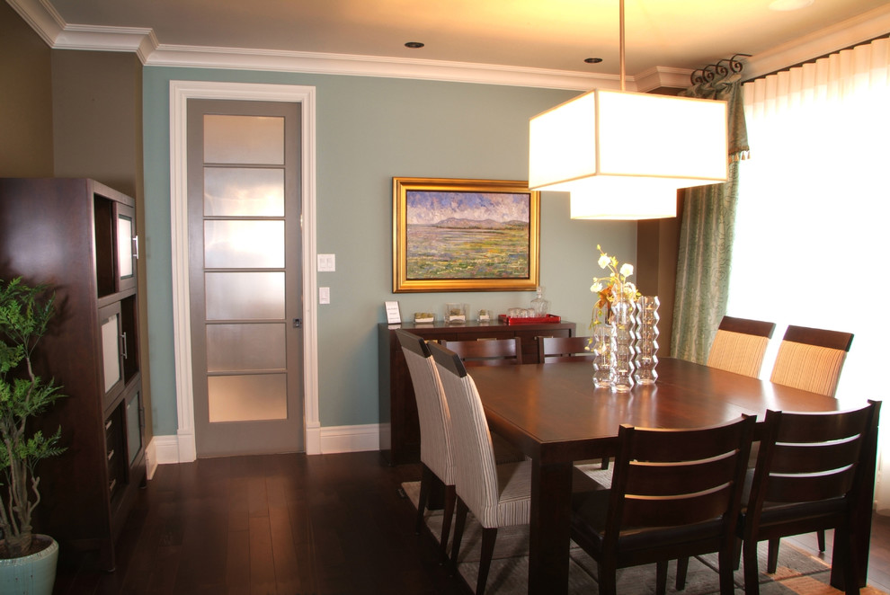 Classic dining room in Other with blue walls and dark hardwood flooring.