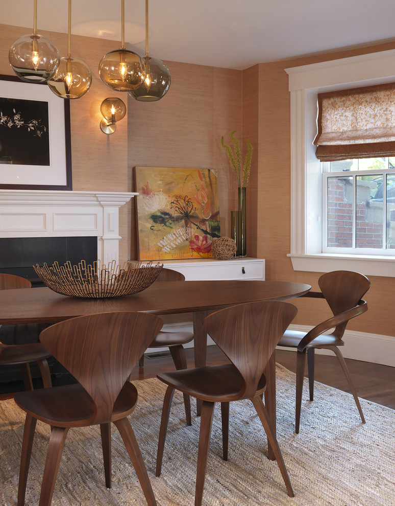 Transitional dark wood floor dining room photo in Boston with orange walls, a standard fireplace and a wood fireplace surround