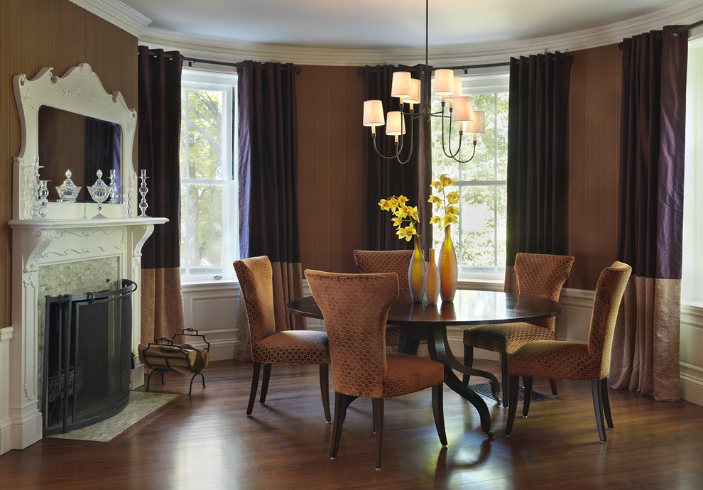 Klassische Wohnküche mit brauner Wandfarbe, dunklem Holzboden, gefliester Kaminumrandung und Kamin in Boston