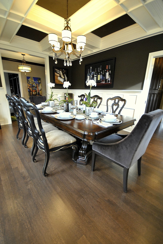 Design ideas for a classic dining room in Edmonton with black walls and dark hardwood flooring.