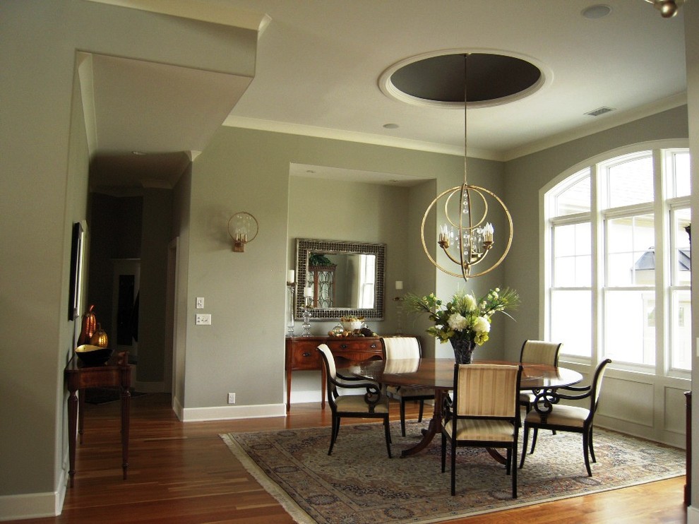 Photo of a large traditional dining room in Other with grey walls, dark hardwood flooring, no fireplace and brown floors.