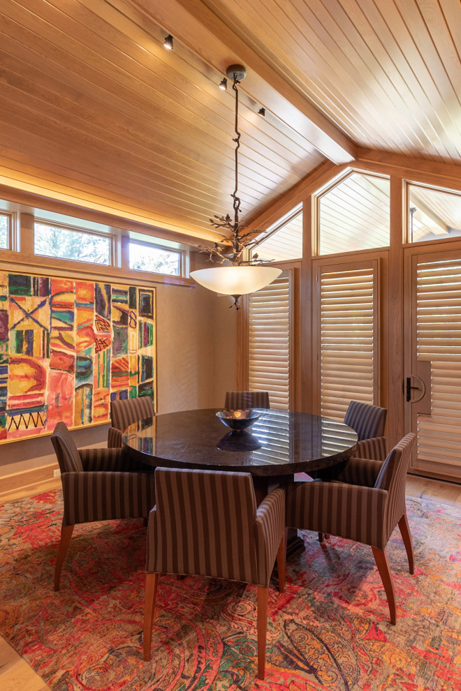 Photo of a classic dining room in Omaha with beige walls, medium hardwood flooring, brown floors, a vaulted ceiling and a wood ceiling.