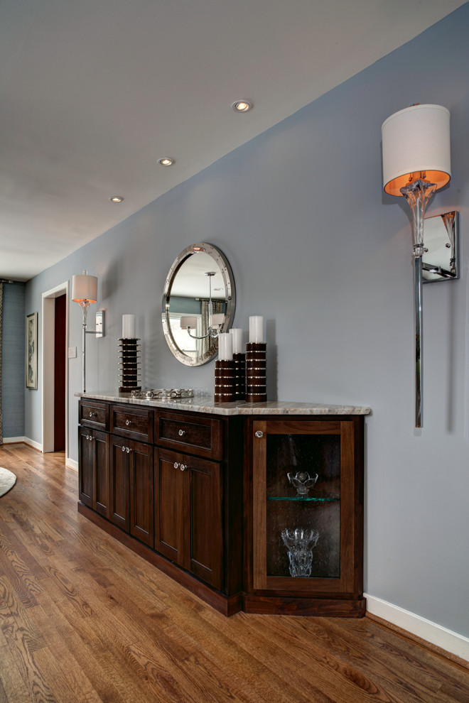 Large eclectic medium tone wood floor great room photo in DC Metro with blue walls and no fireplace