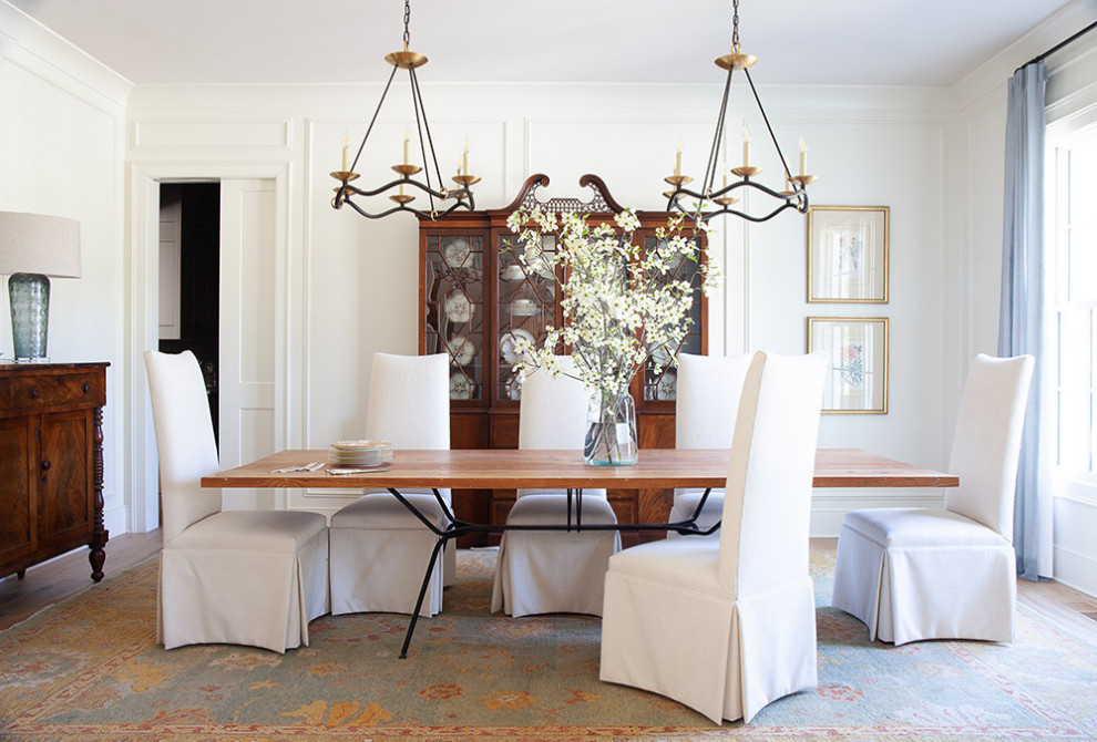 Example of a classic wall paneling enclosed dining room design in Nashville with white walls and no fireplace